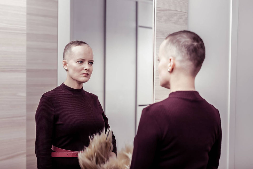 Serious woman with short hair looking at her reflection in the mirror, symbolising self-awareness and decision-making capacity in legal proceedings