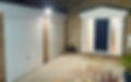 Two white new garage doors and sandstone paving