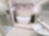Traditional bathroom with double ended free standing bath on raised plinth, with walk in shower and basin
