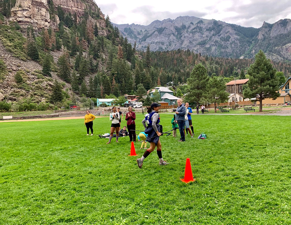 Ultra running coach crossing the Ouray 100 mile finish line
