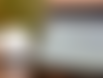 Tablet on desk displaying Google search homepage with coffee cup in background.