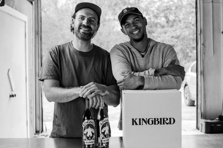 Two men smiling holding their Vermouth brand, Kingbird
