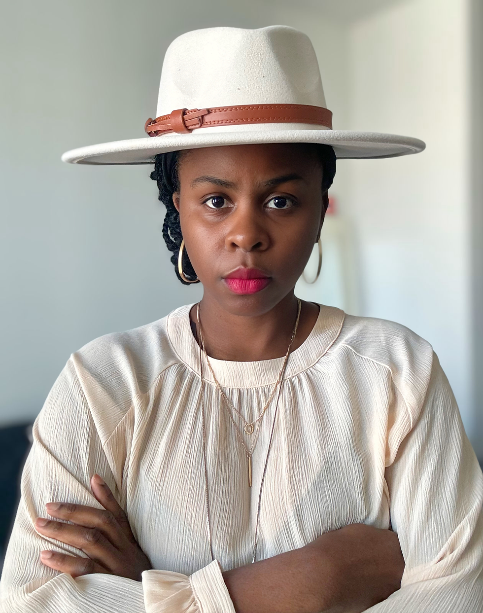 Thumbnail: Woman wearing hat and necklace looking directly at the camera with arms crossed.