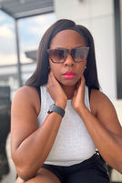 Thumbnail: Woman wearing sunglasses poses for a photo outside with a blurred background