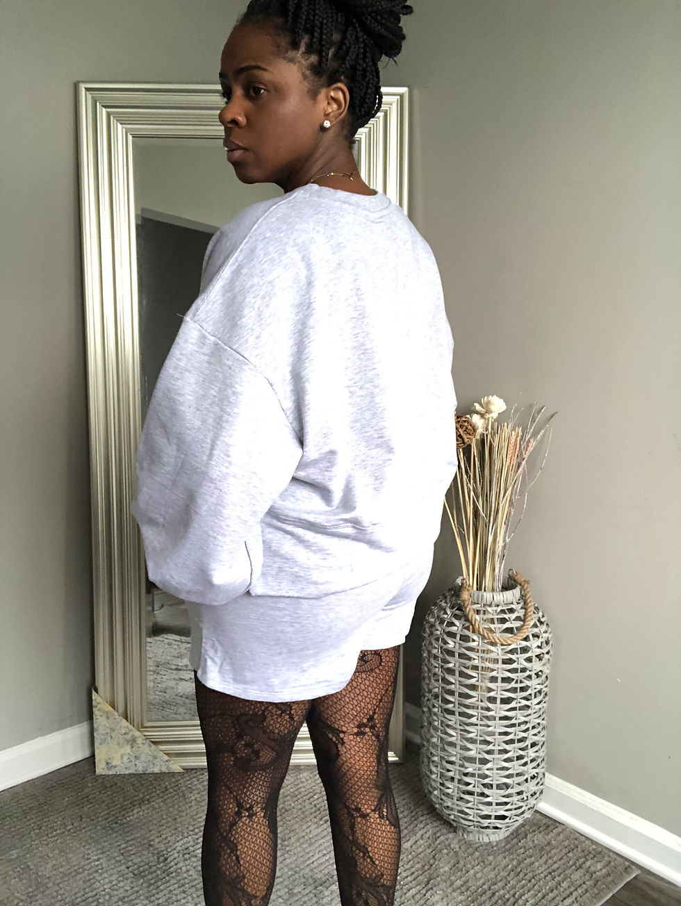 Thumbnail: Woman poses in gray sweatshirt dress near a standing mirror and vase.