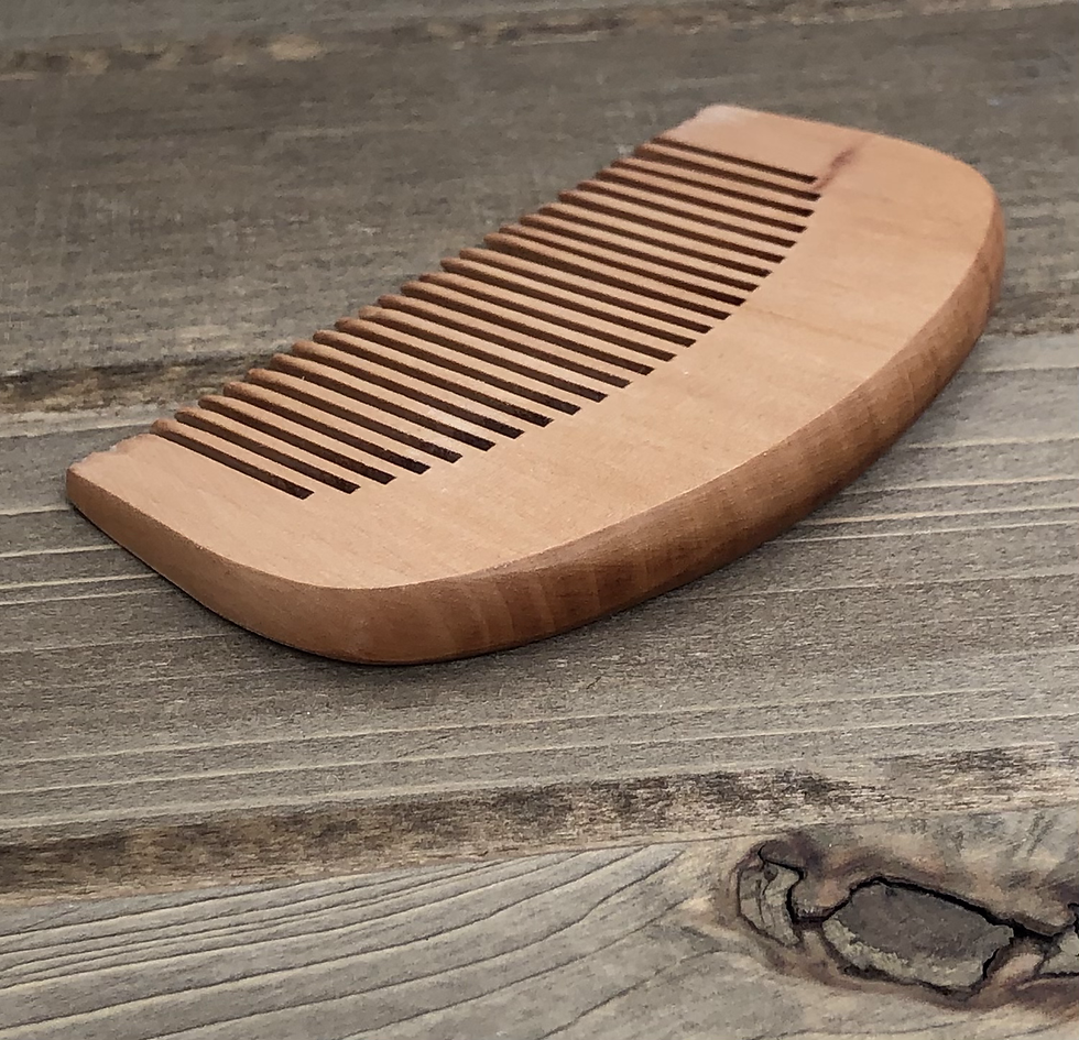 Thumbnail: Wooden comb on rustic wooden surface for grooming and beard care.