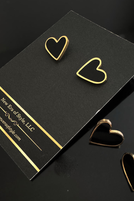Thumbnail: Black heart earrings on a black display card, New Era of Style logo