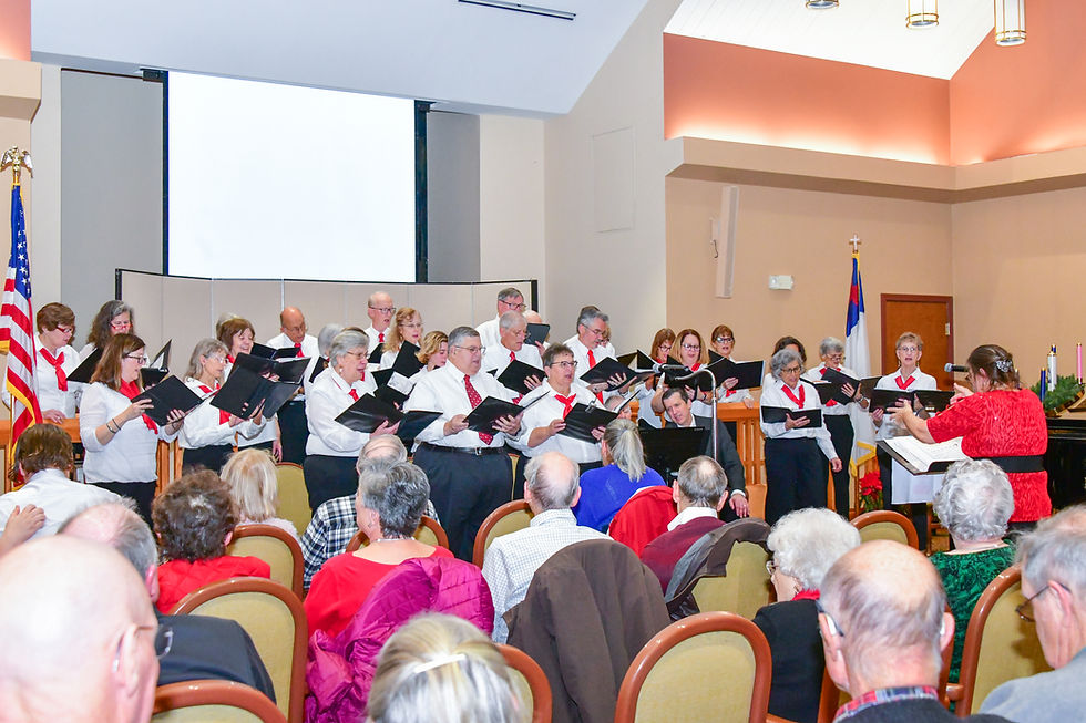 group of people singing before an audience