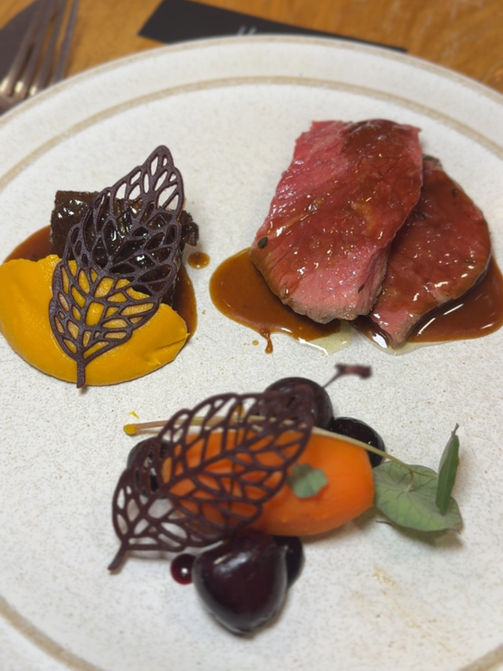 Plate with food, meat and vegetables. Enigma Dining & Events.