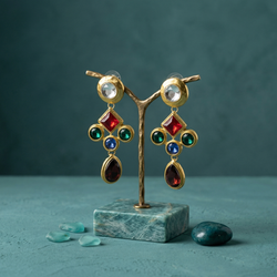 Pair of ornate multi-color gemstone drop earrings with matte gold settings featuring red, green, blue, and burgundy stones.