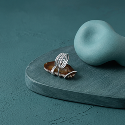 Handcrafted silver wire-wrapped agate slice statement ring with honey tones and decorative swirls. MHL Jewelry Designs.