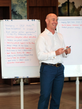 Jono Heath standing near a whiteboard during a strategy discussion.