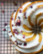 Overhead view of Orange Ricotta Bundt Cake with Rose Icing, decorate with rose petals.