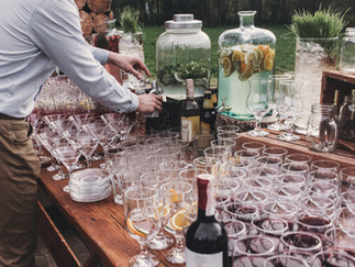 Rustic wedding catering with cocktails and drinks arranged on a wooden table