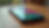 Eye-level view of a smartphone with a colorful protective case on a wooden table