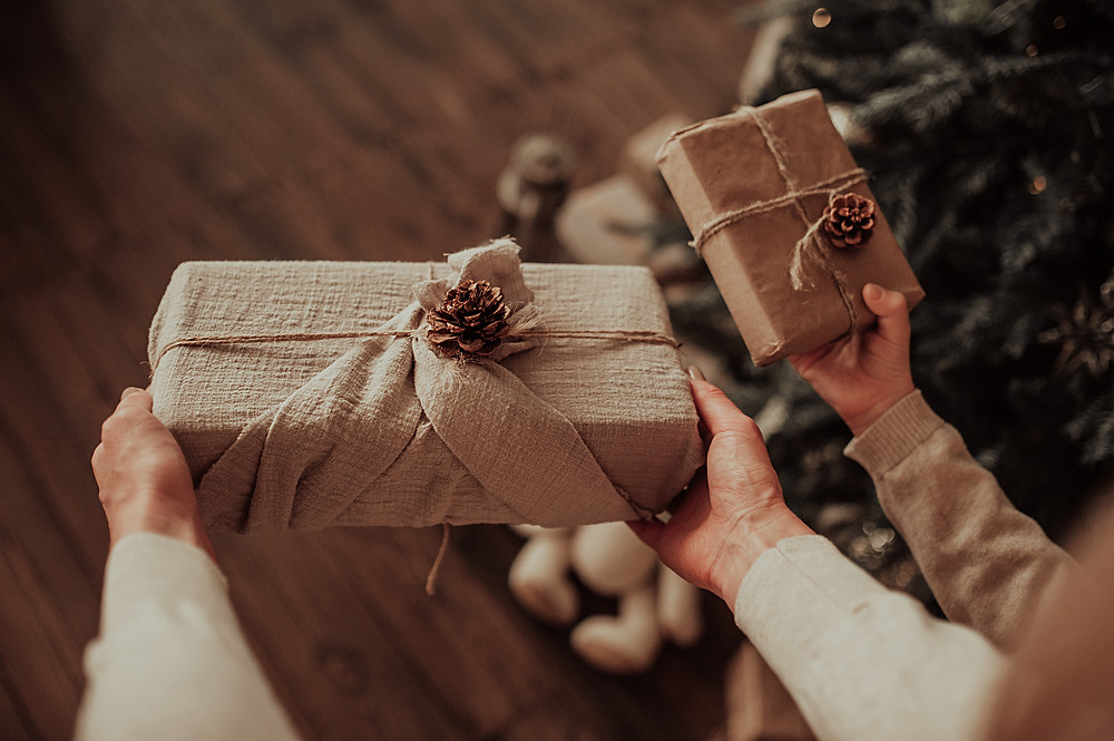 Christmas gift being given in eco friendly gift wrap