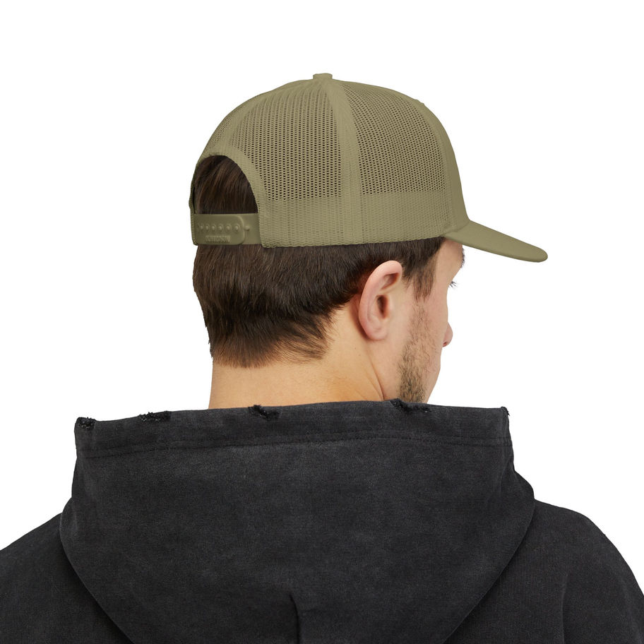 Man in olive green trucker cap featuring a coquí, perfect for traveling to puerto rico with karaya travel