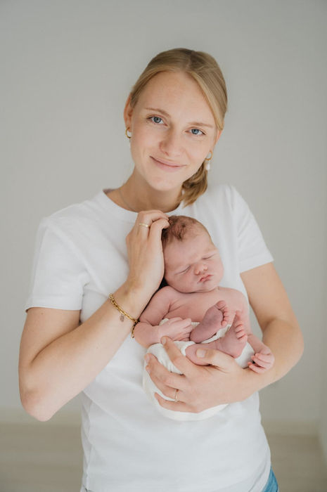 Neugeborenenshooting in München - Mama mit Baby auf dem Arm