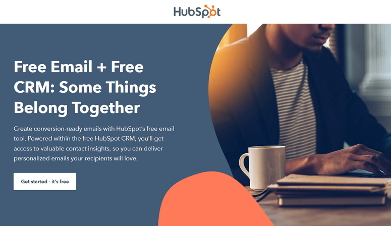 Person in striped shirt using a laptop with coffee, next to text: Free Email + Free CRM. HubSpot logo and call-to-action button visible.