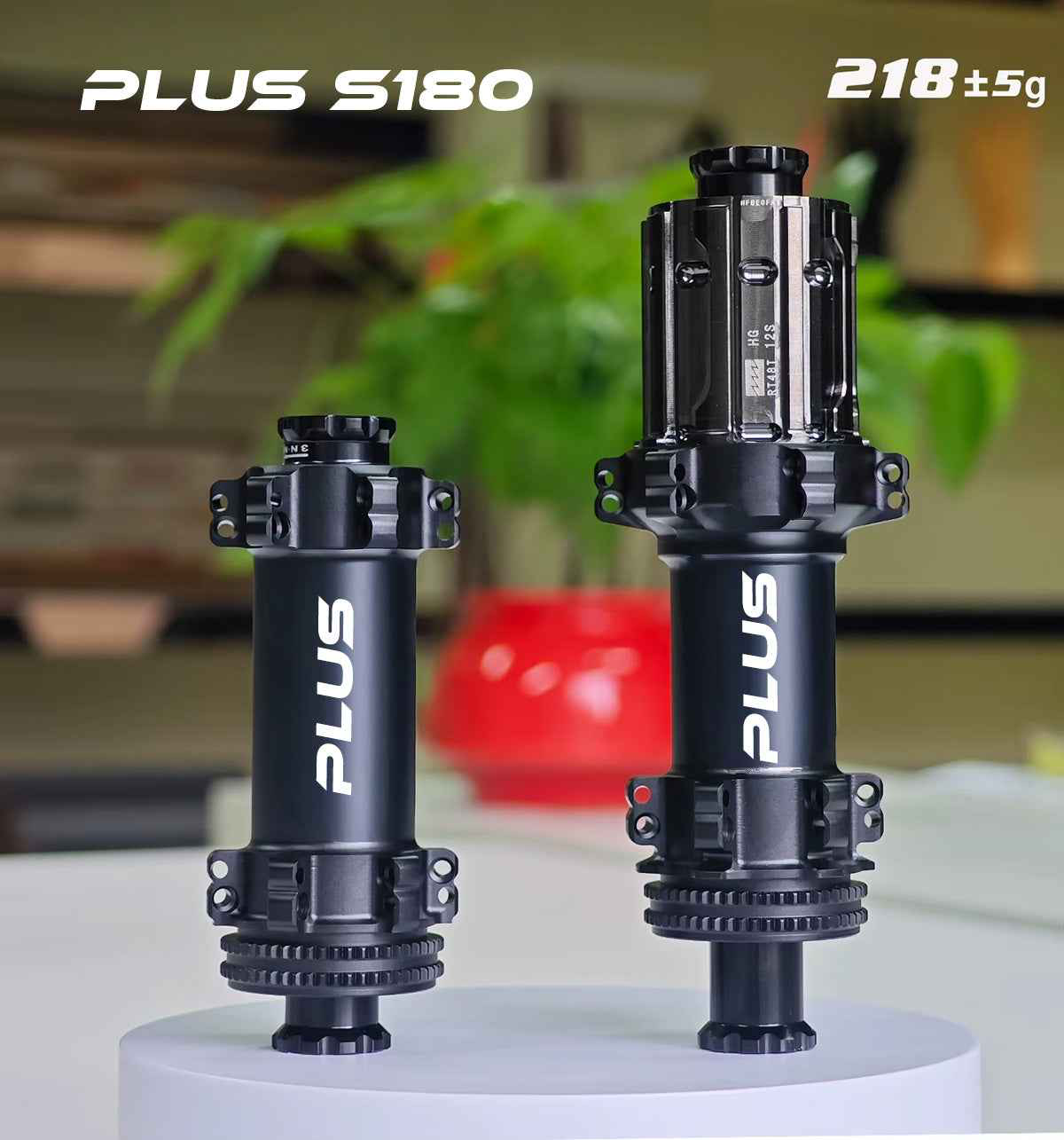 Two black PLUS S180 ratchet hubs, one smaller, one larger