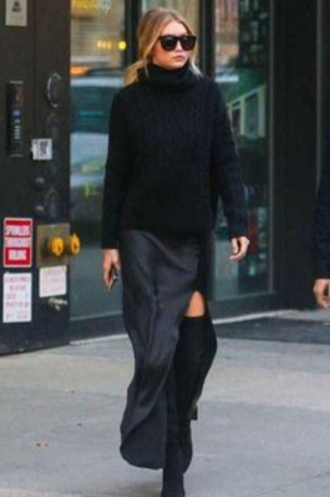 Woman wearing a sweater over a dress
