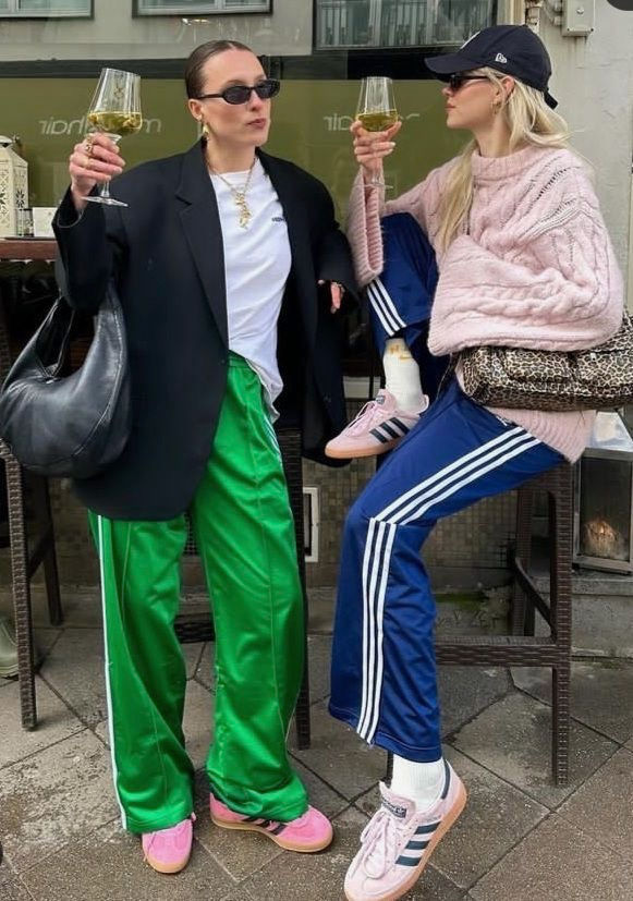 Two girls wearing track pants and accessories