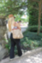 Woman walking down the street on her camera