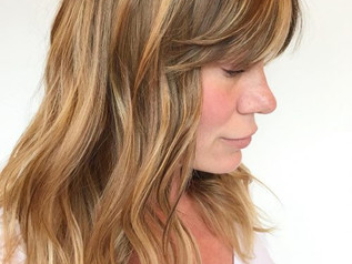 Medium Layered Haircut with Side Swept Bangs