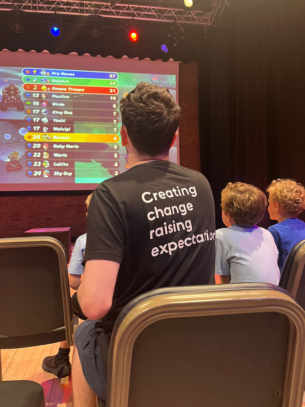 GCT Gaming Social volunteer with young peoiple and big screen gaming at Gosforth Civic Theatre
