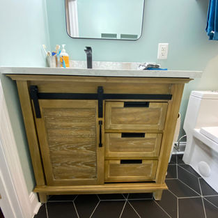 Bathroom vanity next to glass shower wall