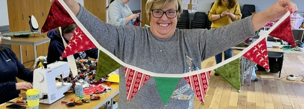 woman holding christmas style triangular bunting