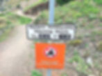 Sign stating the opening hours of Acrocorinth in Greece.