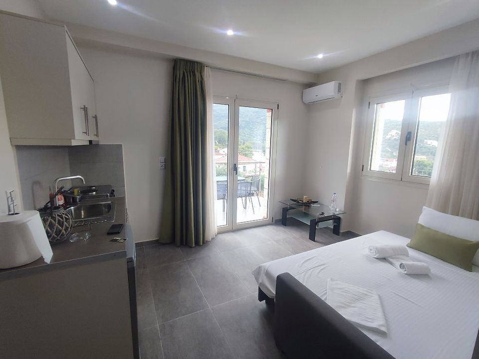 Living room with sofa bed at Tresor Apartments in Parga, Greece.