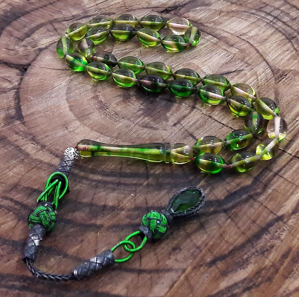 Close-up view of amber prayer beads on a wooden surface