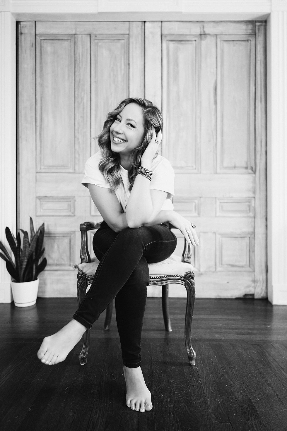 Woman smiling and sitting in a chair
