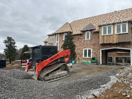 American Excavation SVL 97-2 compact track loader spreading gravel at a custom home build site in Middle Tennessee.
