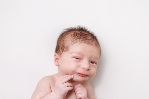 newborn baby boy expression headshot on white background, newborn mugshot, fishers indiana newborn photographer