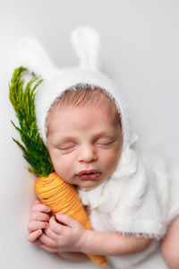 newborn session, newborn photographer near me, newborn baby boy in heart prop, newborn baby boy grey portrait, newborn photographer, newborn photography, newborn portraits, newborn boy with carrot, newborn boy photos, Newborn baby in bunny outfit
