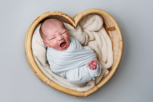 newborn posing, newborn session, newborn photography, potato sack pose, newborn wrapped poses, newborn photographer near me, newborn baby in heart prop, newborn boy on blue, newborn baby yawn, newborn session heart prop
