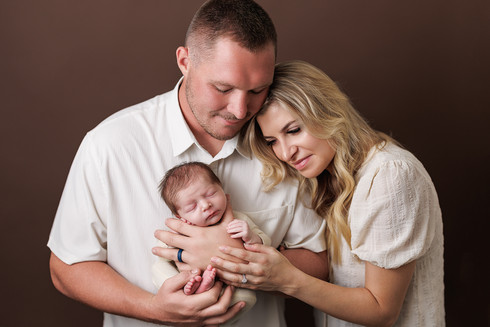family newborn photography on brown background