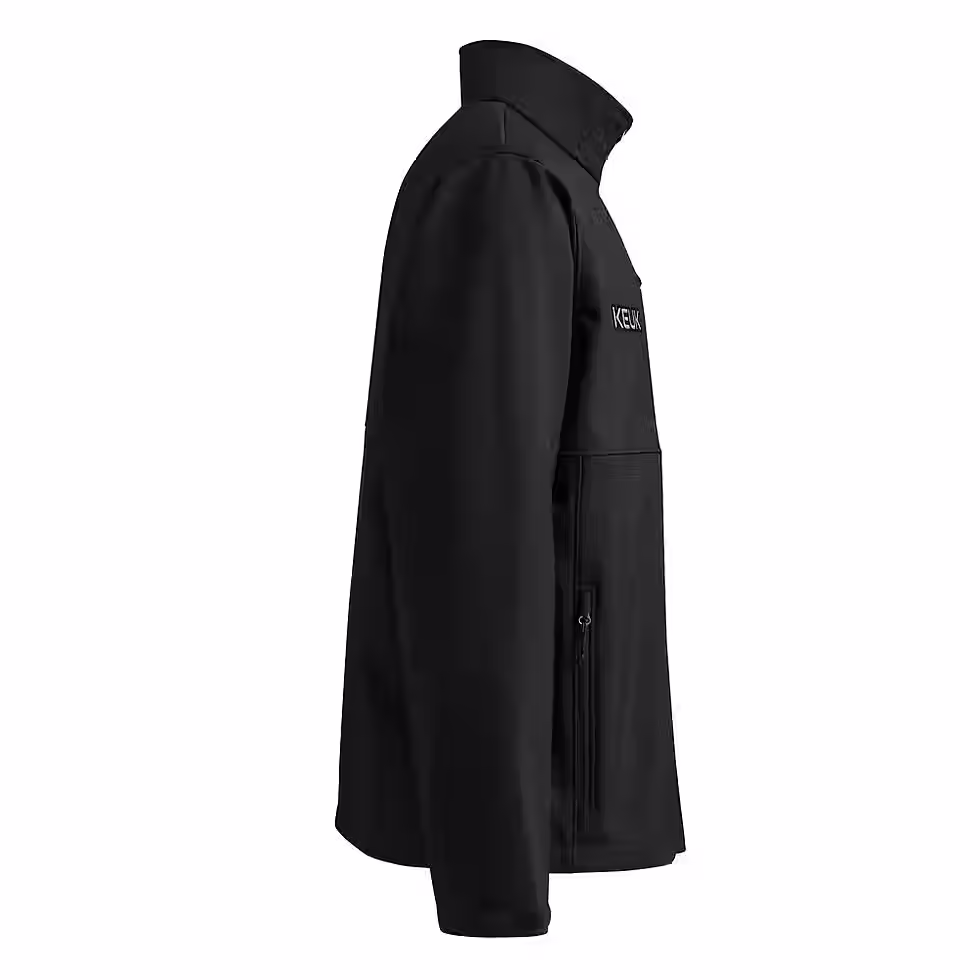 High angle view of a soft shell jacket on a hiking trail with vibrant greenery surrounding it.
