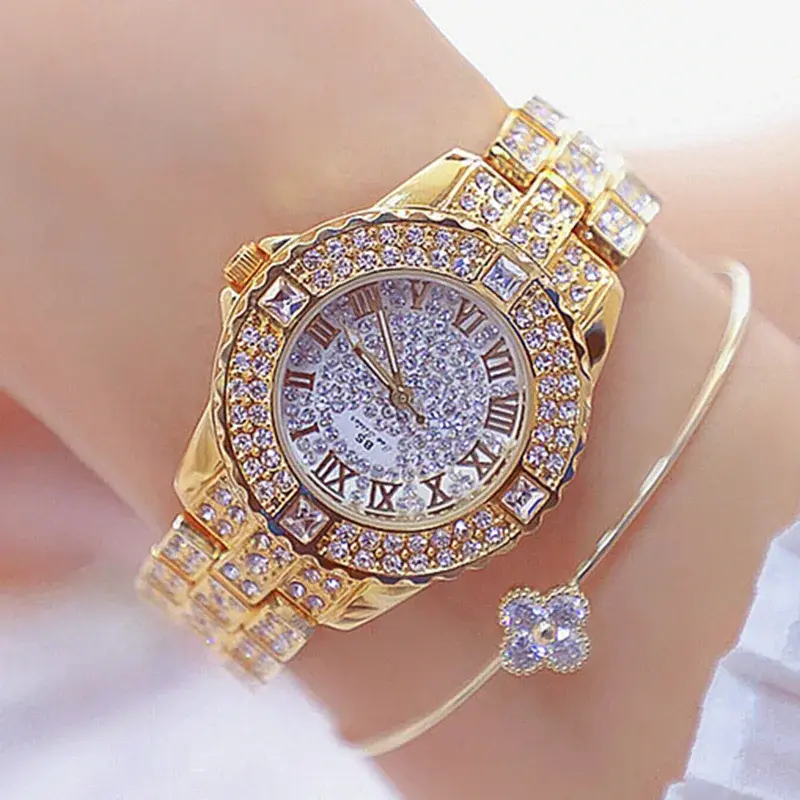 Thumbnail: Gold gem-studded watch and delicate bracelet