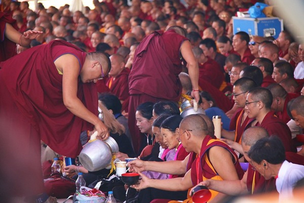 Monks prepare and serve free tea and lunch to over 30,000 attendees of Buddhist teachings in new prayer hall of Tashi Lhunpo.