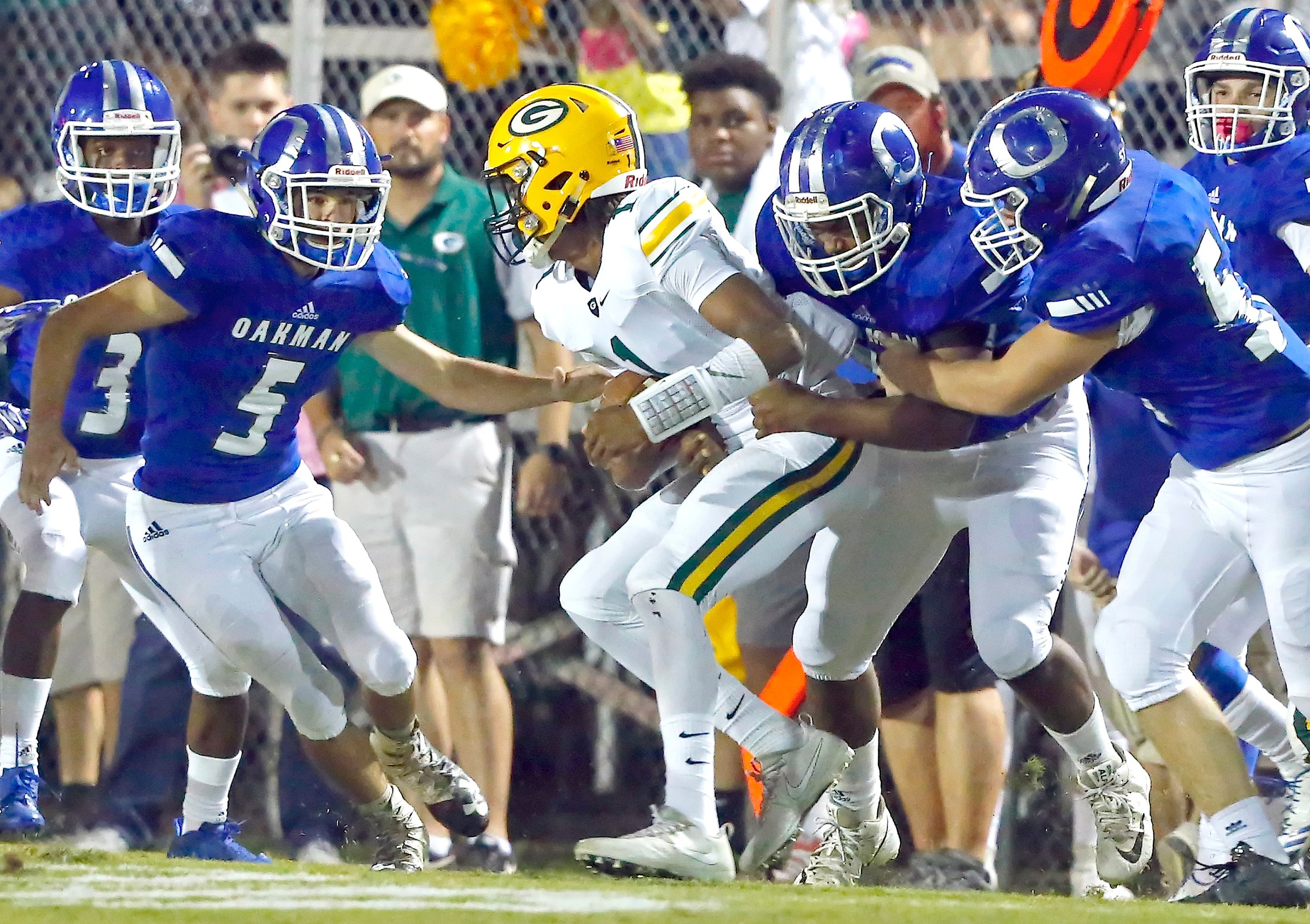 Oakman defenders converge on Gordo’s Essie Davis (1) during their game Friday night at Oakman. Gordo beat the Wildcats 47-20.
