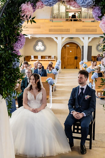 The couple seated in the choir, the nave behind them