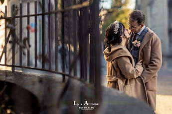 The couple in their coats near the cathedral railings