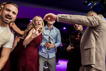 Guests dancing under purple lights