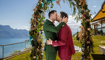 A kiss beneath the arch, with the lake behind
