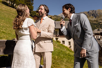 The couple face to face, the officiant beside them