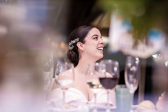 Gemma smiles, behind the glasses on the table